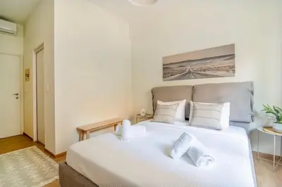 a bedroom with a large white bed with white pillows at Luana's Charming Apart in Pagrati in Athens