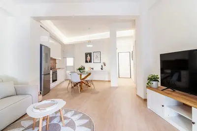 a living room with a couch and a tv at Luana's Charming Apart in Pagrati in Athens