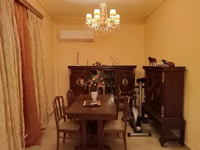 a dining room with a table and a chandelier at Eleni's Astrous Home in Athens