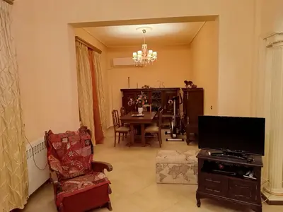 a living room with a television and a dining table at Eleni's Astrous Home in Athens