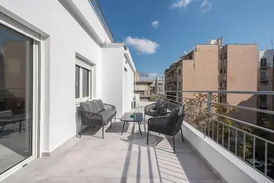 a balcony with chairs and a table on a building at Zen Top, Exarchia in Athens