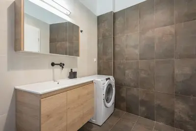 a bathroom with a washing machine and a sink at Zen Top, Exarchia in Athens