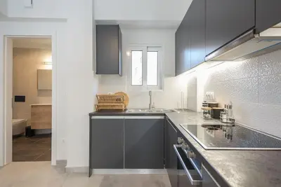 a kitchen with gray cabinets and a counter top at Zen Top, Exarchia in Athens
