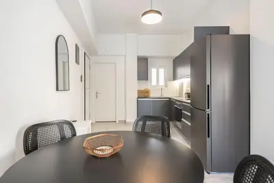 a kitchen with a table and chairs and a refrigerator at Zen Top, Exarchia in Athens