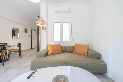 a living room with a couch and a table at Zen Top, Exarchia in Athens