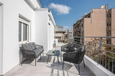 a balcony with chairs and a table on a building at Zen Top, Exarchia in Athens