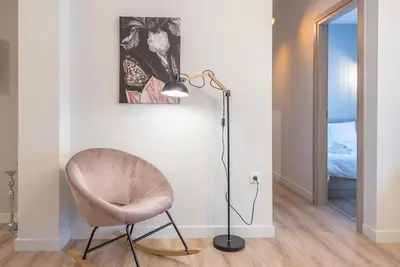 a floor lamp and a chair in a room at Modern & Spacious Αpartment in Athens