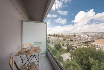 a balcony with a table and a large window at Modern & Spacious Αpartment in Athens