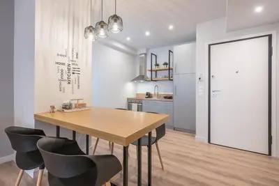 a kitchen with a wooden table and black chairs at Modern & Spacious Αpartment in Athens