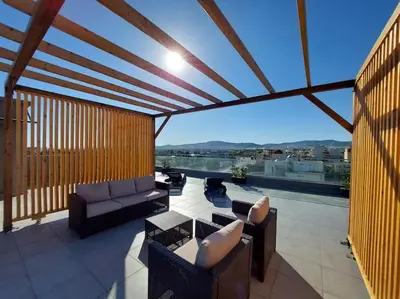 a patio with couches and a balcony with a view at Modern & Spacious Αpartment in Athens