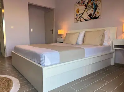a large white bed in a bedroom with two lamps at The Penthouse Private Jacuzzi & Lycabettus View in Athens