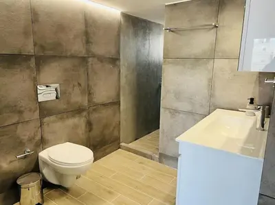 a bathroom with a toilet and a sink at The Penthouse Private Jacuzzi & Lycabettus View in Athens