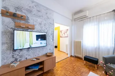 a living room with a television on a wall at Medluxe SMART APARTMENT! in Athens