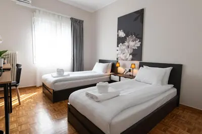 a hotel room with two beds and a window at Medluxe SMART APARTMENT! in Athens