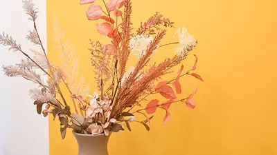 a white vase filled with flowers on a table at Medluxe SMART APARTMENT! in Athens