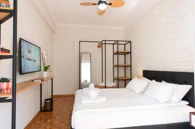 a bedroom with a white bed and a shelf at Medluxe SMART APARTMENT! in Athens