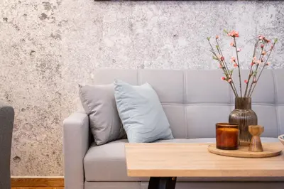 a living room with a couch and a table with a vase at Medluxe SMART APARTMENT! in Athens