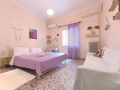 a bedroom with two beds and a window at Dolce Casa an athenian residence with private garden in Athens