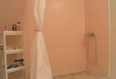 a shower with a shower curtain in a bathroom at Dolce Casa an athenian residence with private garden in Athens