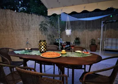 a wooden table with a plate of food on it at Dolce Casa an athenian residence with private garden in Athens