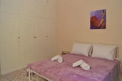 a bedroom with a bed with two pillows on it at Dolce Casa an athenian residence with private garden in Athens