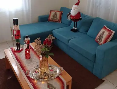 a living room with a santa clause on a blue couch at Dolce Casa an athenian residence with private garden in Athens
