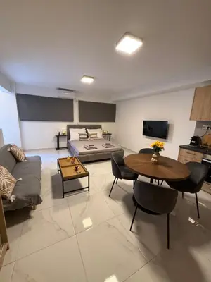 a living room with a couch and a table at Prime apartment in Athens