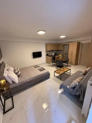 a living room with two beds and a table at Prime apartment in Athens