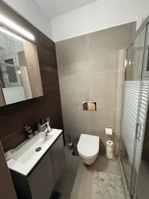 a bathroom with a toilet and a sink and a shower at Prime apartment in Athens