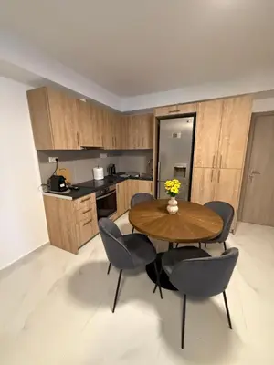 a kitchen with a wooden table and chairs in a room at Prime apartment in Athens