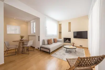 a living room with a couch and a table at Modern 2BDR Flat w Hot Tub & Big Terrace in Plaka in Athens