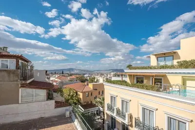 a view of the city from the balcony of a house at Modern 2BDR Flat w Hot Tub & Big Terrace in Plaka in Athens