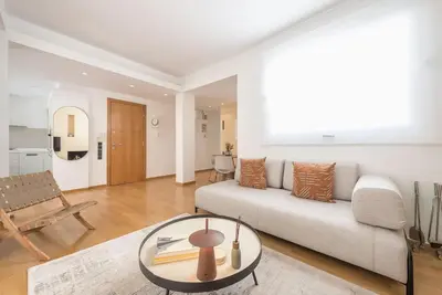 a living room with a couch and a table at Modern 2BDR Flat w Hot Tub & Big Terrace in Plaka in Athens