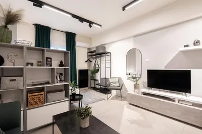 a living room with a large flat screen tv at Modern Studio, Walking distance to Kolonaki & The Ilisian in Athens