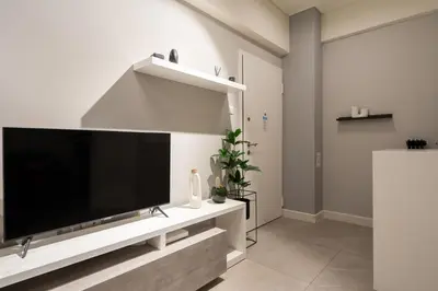 a living room with a large flat screen tv at Modern Studio, Walking distance to Kolonaki & The Ilisian in Athens