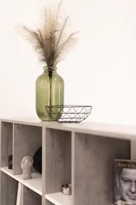 a vase with grass in it sitting on a shelf at Modern Studio, Walking distance to Kolonaki & The Ilisian in Athens