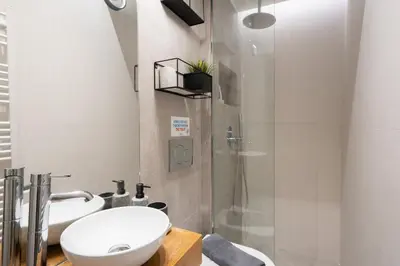a bathroom with a toilet and a sink and a shower at Modern Studio, Walking distance to Kolonaki & The Ilisian in Athens