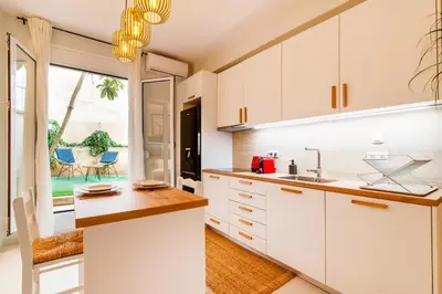 a kitchen with white cabinets and a counter top at Solonaki Luxury Studio Apt in the heart of Athens in Athens