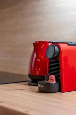 a red toaster and a red cup on a table at Solonaki Luxury Studio Apt in the heart of Athens in Athens