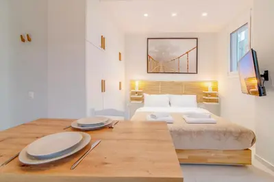 a bedroom with a bed and a table with plates on it at Solonaki Luxury Studio Apt in the heart of Athens in Athens
