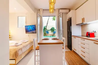 a room with a bed and a kitchen with a counter at Solonaki Luxury Studio Apt in the heart of Athens in Athens