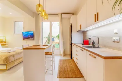 a kitchen with a sink and a bed in a room at Solonaki Luxury Studio Apt in the heart of Athens in Athens