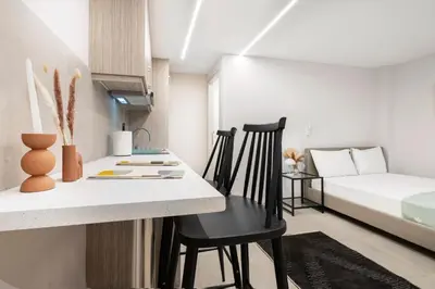 a small apartment with a kitchen and a bed at Oculus Kolonos Suites by Live&Travel in Athens