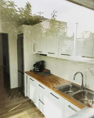 a kitchen with white cabinets and a sink at Athens Hill Suite 2 in Athens