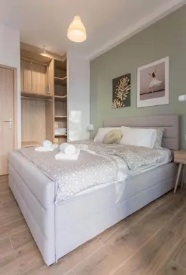 a bedroom with a large bed with two towels on it at Athens Hill Suite 2 in Athens