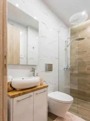 a bathroom with a toilet and a sink and a shower at Athens Hill Suite 2 in Athens