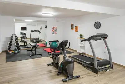 a gym with several exercise equipment in a room at Athens Hill Suite 2 in Athens