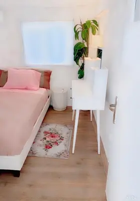 a bedroom with a bed and a desk and a table at Chateau Lykabettus in Athens