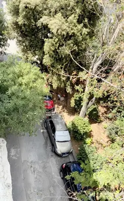 an overhead view of two cars parked in a parking lot at Chateau Lykabettus in Athens