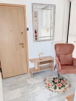 a room with a chair and a table and a mirror at Chateau Lykabettus in Athens